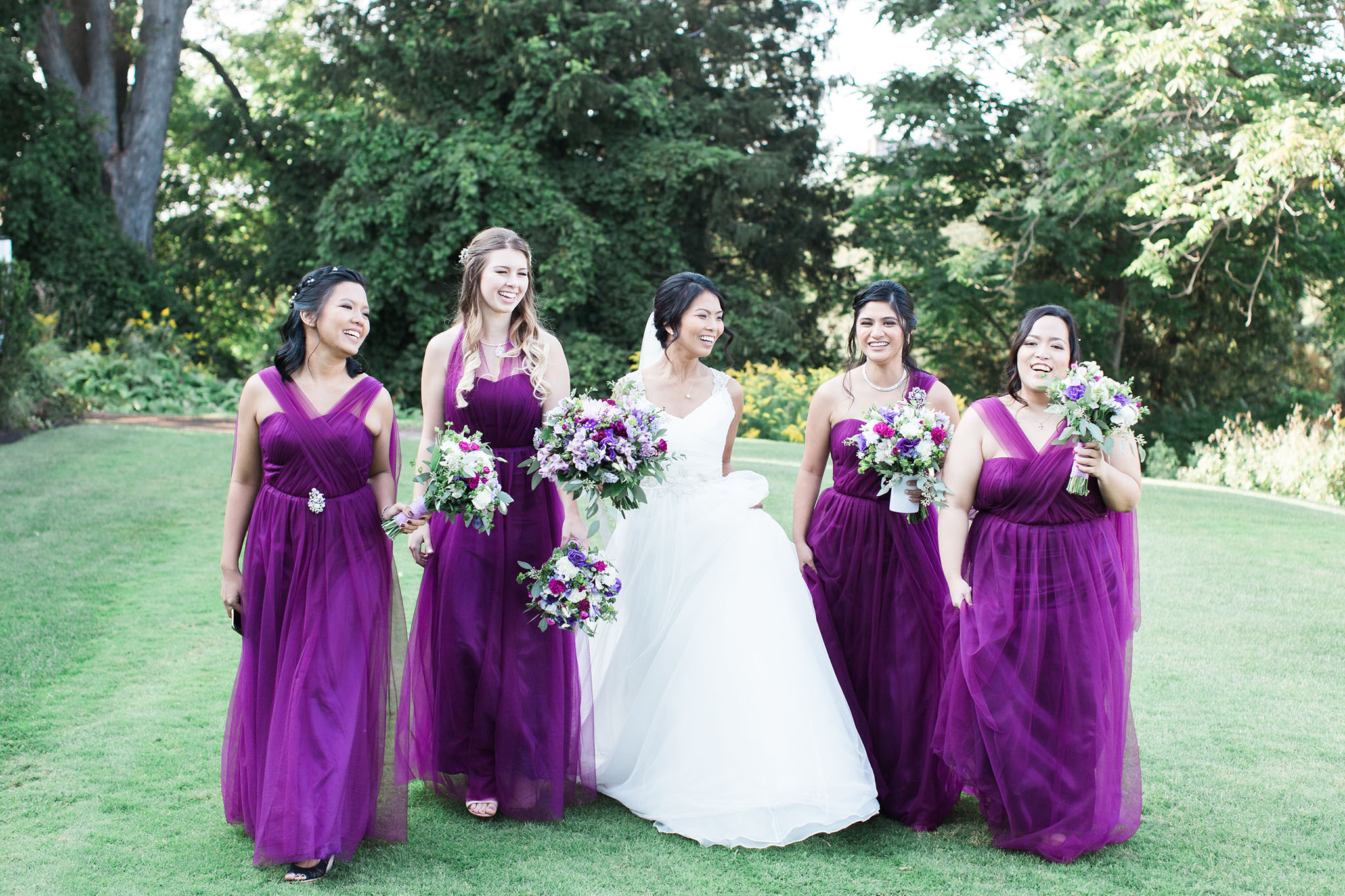 The deep purple dresses on the bridesmaids is eye grabbing in this photo.